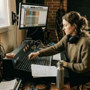 Female producer working in cluttered studio